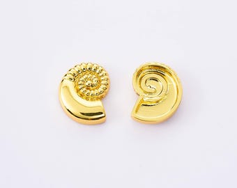 May include: Two gold-colored seashell-shaped earrings. Each earring has a spiral design, with one featuring a detailed, textured top. The earrings are set against a white background, highlighting their bright, reflective surface. These earrings are a jewelry accessory.