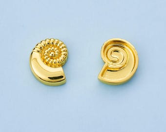 May include: Two gold-colored, seashell-shaped earrings. Each earring features a spiral design with a textured surface. The earrings are set against a light blue background.