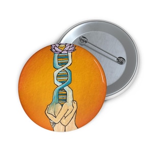 May include: A button featuring a painting of two figures embracing, with a DNA strand and a purple flower on top. The background is a vibrant orange.