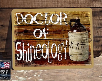 May include: A rustic wooden sign with the text "Doctor of Shineology" in white lettering. A white ceramic jug with black markings and the letters "XXX" is on the right side of the sign.