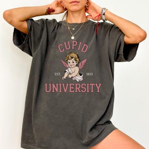 Cupid University Graphic T-Shirt | Vintage Cherub Angel Shirt | Retro Valentine Shirt | Cute Cupid Aesthetic Tee | Gift for Her