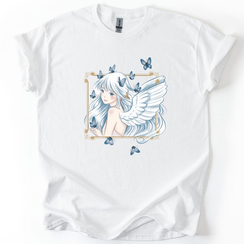 May include: White t-shirt featuring a detailed illustration of a woman with long white hair, angel wings, and blue butterflies. The artwork is framed in a gold border. The design is centered on the shirt.