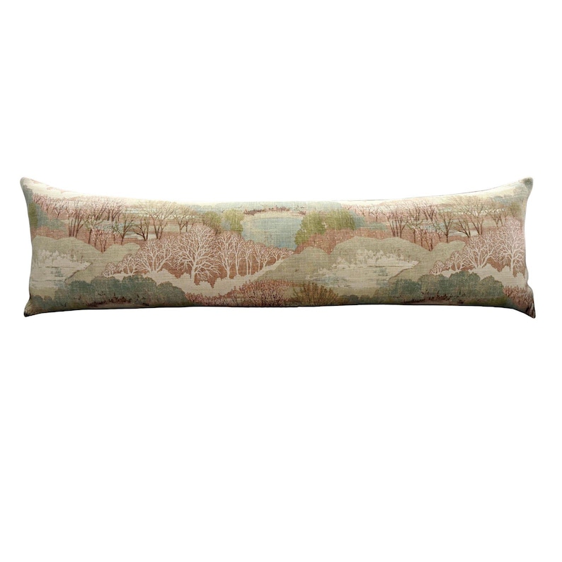 Long linen lumbar pillow showcasing a continuous pastoral landscape pattern with soft blush pink, sage green, cream, and muted blue tones. Inspired by traditional countryside scenery, this decorative lumbar pillow complements English cottage, vintage, grandmillennial, and neutral farmhouse interiors with timeless elegance.
