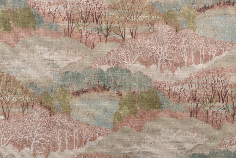 Close-up of the pastel landscape linen fabric featuring delicate trees, rolling hills, and soft blush pink, sage green, cream, and blue tones.