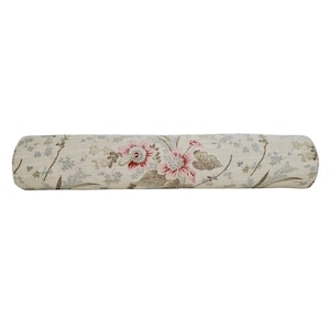May include: A cylindrical bolster pillow with a floral print. The fabric is a light beige with a pattern of pink, red, and green flowers and leaves.