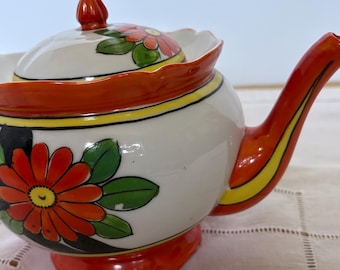 Tetera japonesa MCM colorida de los años 50, color naranja con motivo floral.