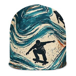 May include: A beanie featuring a graphic print of a skateboarder in a crouched position against a background of swirling teal, blue, and cream-colored waves with orange accents. The design includes a silhouette of a person on a skateboard.