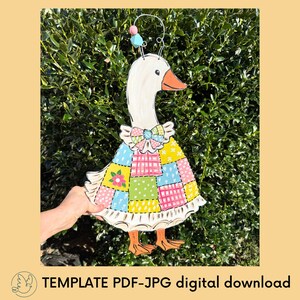 May include: A wooden goose decoration with a white head, orange beak, and a patchwork dress in various colours. The goose has a decorative bow and a wire with beads on top. The text "TEMPLATE PDF-JPG digital download" is at the bottom.