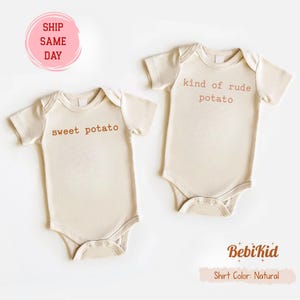 May include: Two beige baby onesies with short sleeves. One onesie has the text "sweet potato" printed in brown, and the other says "kind of rude potato." The onesies are from BekiKid, with a natural shirt colour.