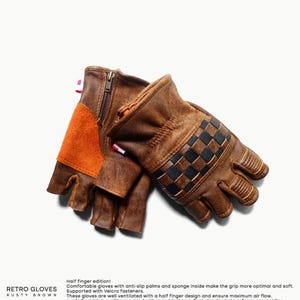 May include: A pair of brown leather motorcycle gloves with a half-finger design. The gloves have a checkered pattern on the back of the hand and a zipper on the wrist. The text "Retro Gloves Rusty Brown" is visible at the bottom of the image.
