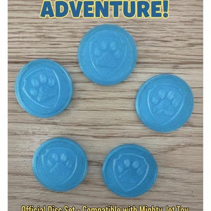 May include: Five circular light blue 3D printed discs, each featuring an embossed paw print inside a shield shape. The text "LAUNCH INTO ADVENTURE!" appears at the top, and "Official Disc Set - Compatible with Mighty Jet Toy Set of 5 3D Printed Discs" is at the bottom.