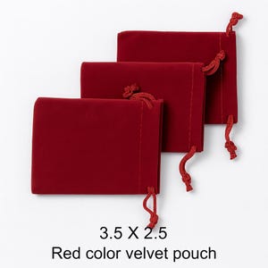 May include: Three red velvet pouches with drawstring closures. Each pouch is rectangular, measuring 3.5 x 2.5 inches. The drawstring is a matching red color. The text at the bottom reads "3.5 X 2.5 Red color velvet pouch."