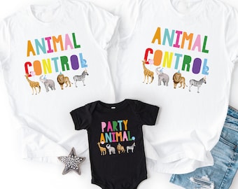 May include: Two white t-shirts with the text ANIMAL CONTROL in colorful letters and a black baby bodysuit with the text PARTY ANIMAL in colorful letters. Each garment features illustrations of a giraffe, elephant, lion, and zebra wearing party hats.