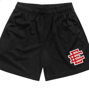 May include: Black athletic shorts with a red and white logo that says "BE" on the right leg.