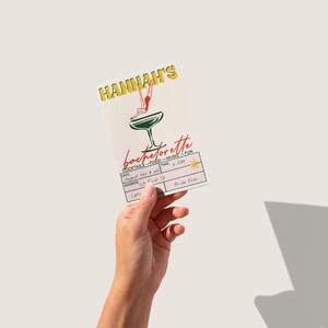 Editable retro bachelorette invitation card with mid-century cocktail theme. Shown held in hand for scale and style.