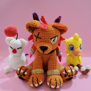 May include: Three crocheted plushies: a red and orange lion with a black eye patch, a white chick with a red heart, and a yellow chick with a blue eye.
