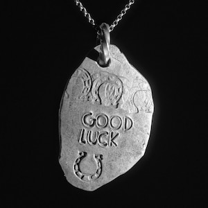 A Lucky Charm Amulet Talisman that says the words &quot;Good Luck&quot; on it to indicate that it is a Good Luck charm - Shibuichi Talisman
