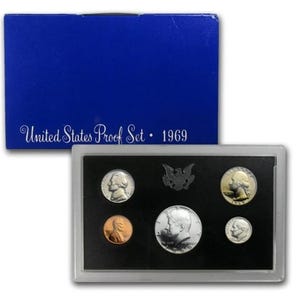 May include: A 1969 United States Proof Set in a blue box. The set includes various coins displayed on a black background within a clear plastic case. The box reads "United States Proof Set 1969".