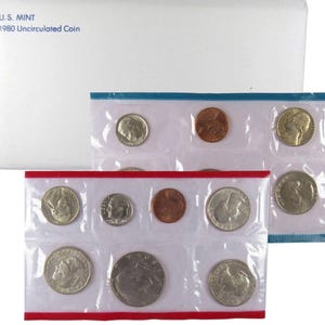 May include: A 1980 Uncirculated Coin set from the U.S. Mint. The set includes various coins sealed in clear plastic, with a white envelope on top. The envelope has the text "U.S. MINT 1980 Uncirculated Coin". The coin sets are in red and blue bordered packaging.