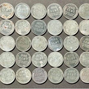 May include: A collection of vintage United States one-cent coins, arranged in rows. The coins are silver in color, with visible wear and tear, and the text "ONE CENT" is clearly visible on each coin.