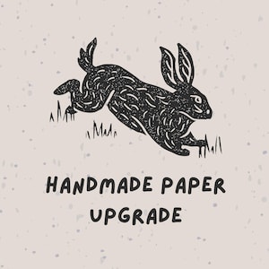 May include: A black illustration of a rabbit leaping over grass against a speckled beige background. The text "HANDMADE PAPER UPGRADE" is below the rabbit in a bold, sans-serif font. The image has a rustic, hand-drawn aesthetic.