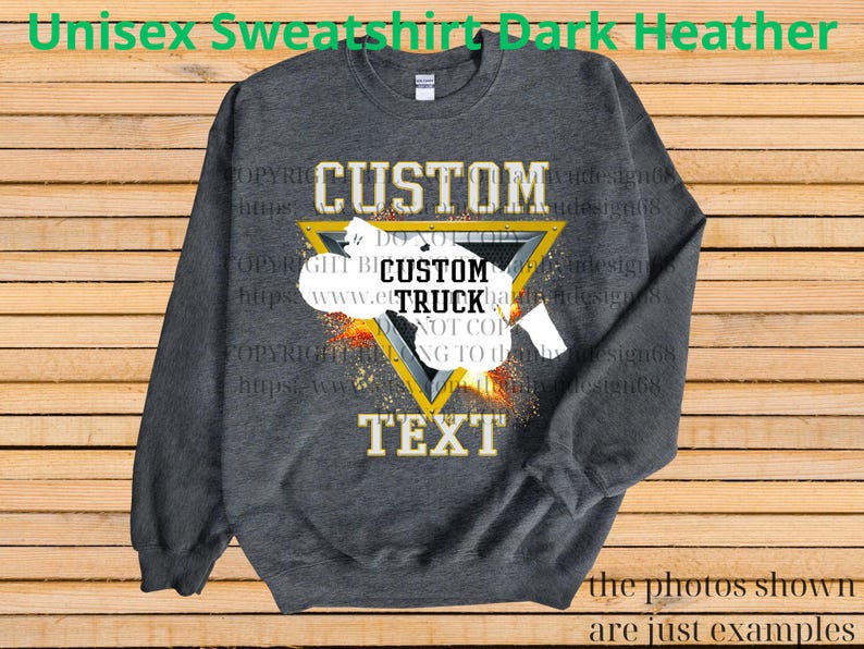 May include: Dark heather grey unisex sweatshirt with a custom design. The design features the word "CUSTOM" above a yellow triangle with the words "CUSTOM TRUCK TEXT" inside. The sweatshirt has long sleeves and a crew neck.