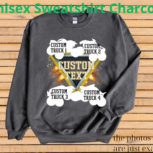 May include: Charcoal gray unisex sweatshirt with a custom text design. The design features a yellow triangle with the words "CUSTOM TEXT" and four white truck graphics. The text "CUSTOM TRUCK" is above and below the triangle. The words "the photos shown are just examples" are at the bottom.