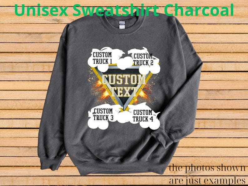 May include: Charcoal gray unisex sweatshirt with a custom text design. The design features a yellow triangle with the words "CUSTOM TEXT" and four white truck graphics. The text "CUSTOM TRUCK" is above and below the triangle. The words "the photos shown are just examples" are at the bottom.