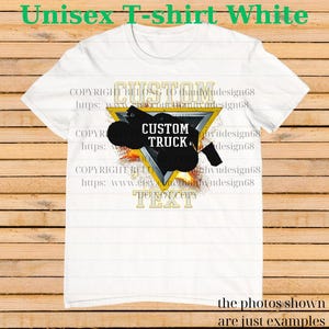 May include: White unisex t-shirt with a graphic design featuring a black truck silhouette inside a yellow triangle. The text "CUSTOM TRUCK" is displayed in white, with additional text above and below the design.