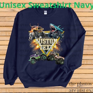 May include: Navy blue unisex sweatshirt featuring a graphic of four monster trucks with the text "CUSTOM TEXT". The sweatshirt has the text "Unisex Sweatshirt Navy" at the top and "the photos shown are just examples" at the bottom.