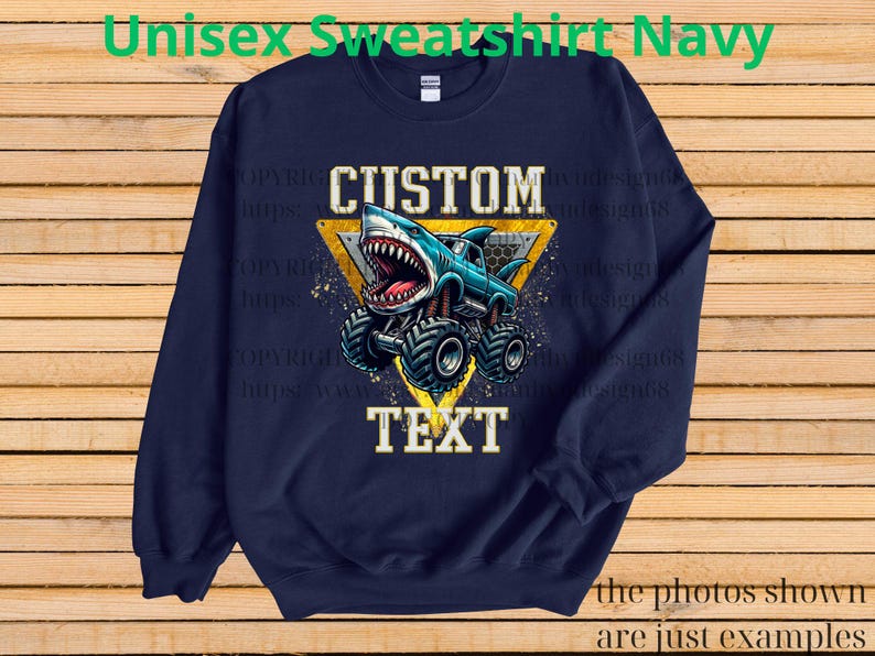 May include: Navy blue sweatshirt with a graphic of a shark-themed monster truck. The design includes the words "CUSTOM" and "TEXT" in a bold font, set against a yellow triangle. The text "Unisex Sweatshirt Navy" is at the top.