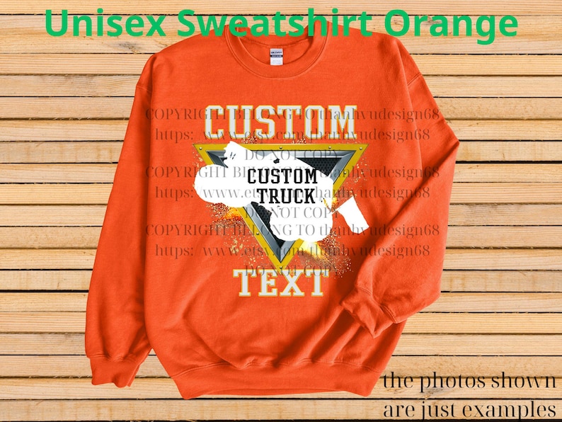 May include: Orange unisex sweatshirt with a custom design. The design features the word "CUSTOM" above a triangle with the words "CUSTOM TRUCK TEXT" inside. The sweatshirt has long sleeves and a crew neck.