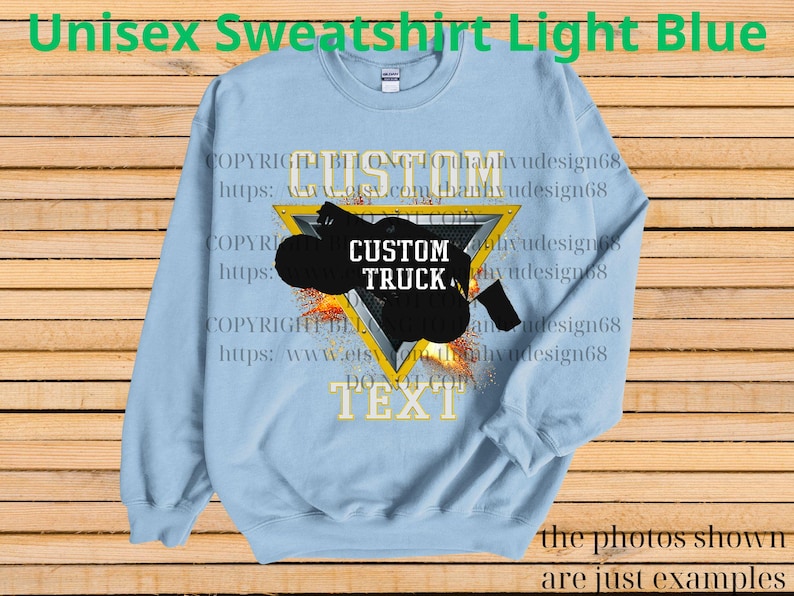 May include: Pale blue unisex sweatshirt featuring a custom truck graphic within a yellow triangle. The design includes the words "CUSTOM TRUCK" and "TEXT". The image also includes the text "COPYRIGHT BELONG TO" and a website address.