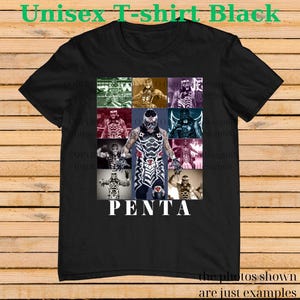 May include: Black unisex t-shirt featuring a collage of images of a wrestler in various poses. The word "PENTA" is printed in white block letters below the images. The shirt has the text "Unisex T-shirt Black" at the top.