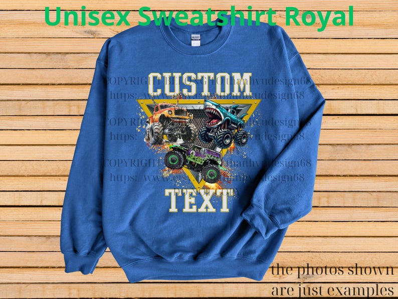 May include: Royal blue unisex sweatshirt with a graphic of three monster trucks in orange, teal, and purple. The sweatshirt has the words "CUSTOM TEXT" in white, and the text "Unisex Sweatshirt Royal" in green.