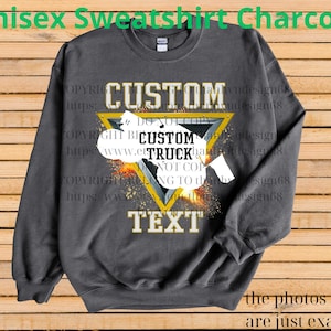 May include: Charcoal grey unisex sweatshirt featuring a custom truck design within a yellow triangle. The sweatshirt displays the words "CUSTOM" and "TEXT" in gold. The text "Unisex Sweatshirt Charcoal" is at the top.