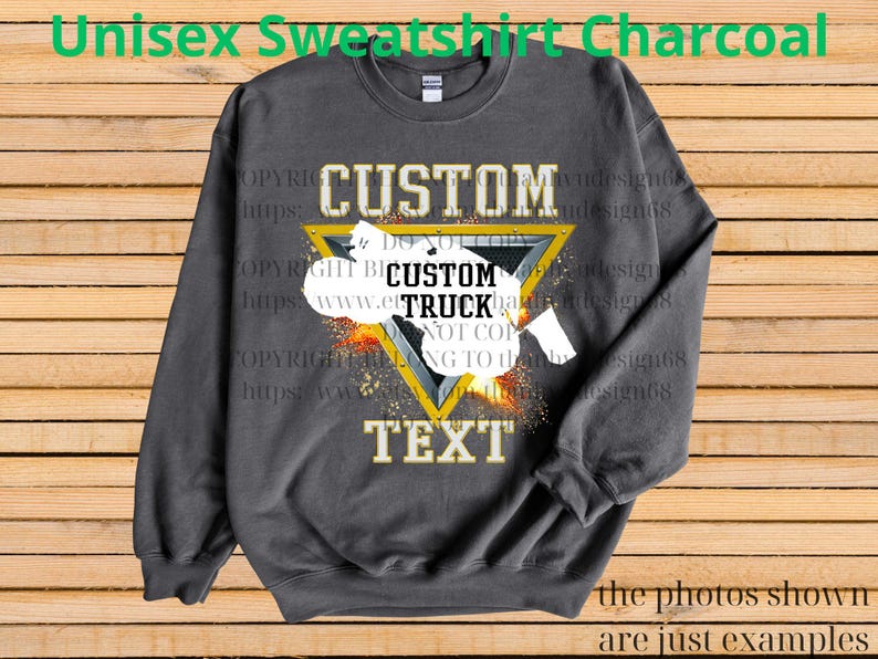 May include: Charcoal grey unisex sweatshirt featuring a custom truck design within a yellow triangle. The sweatshirt displays the words "CUSTOM" and "TEXT" in gold. The text "Unisex Sweatshirt Charcoal" is at the top.