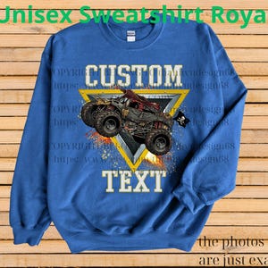 May include: Royal blue unisex sweatshirt with a custom design. The design features a monster truck graphic with the words "CUSTOM TEXT" in white. The sweatshirt has the text "Unisex Sweatshirt Royal" at the top.