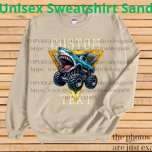 May include: Sand-colored unisex sweatshirt featuring a shark-themed monster truck design. The graphic includes a blue truck with a shark head, large tires, and the text "DO NOT COPY". The sweatshirt also has the text "Unisex Sweatshirt Sand".
