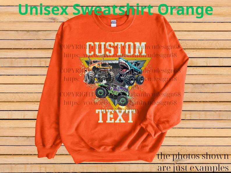 May include: Orange unisex sweatshirt featuring a graphic of three monster trucks with the text "CUSTOM TEXT". The design includes a yellow triangle and the text "the photos shown are just examples".