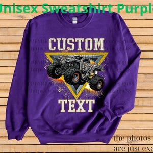 May include: A purple unisex sweatshirt with a custom monster truck design. The design features a monster truck inside a yellow triangle with the word "CUSTOM" above and "TEXT" below. The text "Unisex Sweatshirt Purple" is at the top.