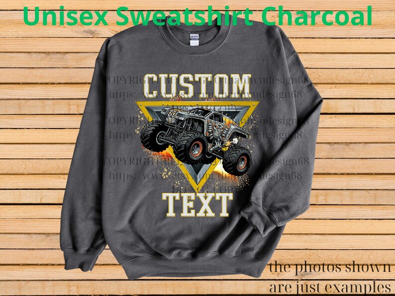 May include: Charcoal grey unisex sweatshirt with a custom monster truck design. The design features a monster truck inside a yellow triangle with the word "CUSTOM" above and "TEXT" below. The text "Unisex Sweatshirt Charcoal" is at the top.