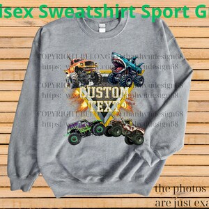 May include: A gray unisex sweatshirt with a graphic of four monster trucks in various colors. The text "CUSTOM TEXT" is in the center. The words "Unisex Sweatshirt Sport Grey" are at the top.
