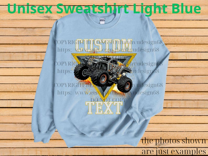 May include: Pale blue unisex sweatshirt with a monster truck design inside a yellow triangle. The words "CUSTOM" and "TEXT" are visible. The sweatshirt also has the text "Unisex Sweatshirt Light Blue".
