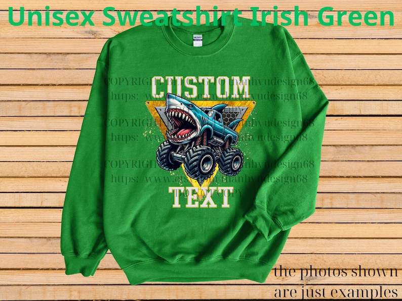 May include: Irish green unisex sweatshirt with a graphic of a shark-themed monster truck. The design includes the words "CUSTOM" and "TEXT" within a yellow triangle. The sweatshirt is made of a soft material.