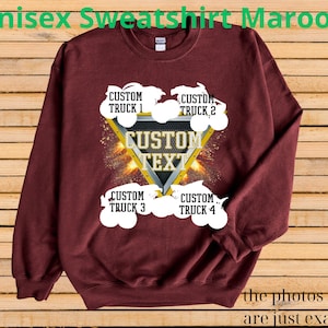 May include: Maroon unisex sweatshirt with a custom design. The design features a yellow triangle with the text "CUSTOM TEXT" and four white truck illustrations. The words "CUSTOM TRUCK" and numbers 1-4 are above and below the trucks. The text "Unisex Sweatshirt Maroon" is at the top.