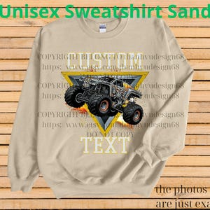 May include: A sand-coloured unisex sweatshirt with a monster truck design inside a yellow triangle. The text "CUSTOM" and "TEXT" are visible. The sweatshirt has long sleeves and a crew neck. The words "Unisex Sweatshirt Sand" are at the top.