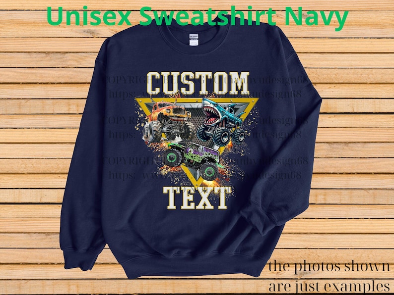 May include: Navy blue sweatshirt with a graphic of three monster trucks in orange, blue, and green. The design includes the words "CUSTOM" and "TEXT" in a yellow triangle. The text "Unisex Sweatshirt Navy" is at the top.
