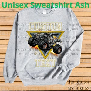 May include: Ash grey unisex sweatshirt with a monster truck design inside a yellow triangle. The design includes the text "CUSTOM TEXT" and "DO NOT COPY TEXT". The sweatshirt has long sleeves and a crew neck.
