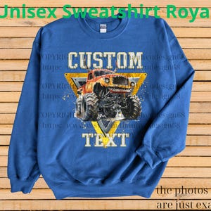 May include: Royal blue unisex sweatshirt with a custom monster truck design. The design features a yellow triangle with the words "CUSTOM" and "TEXT" and a detailed illustration of a monster truck. The text "Unisex Sweatshirt Royal" is at the top.